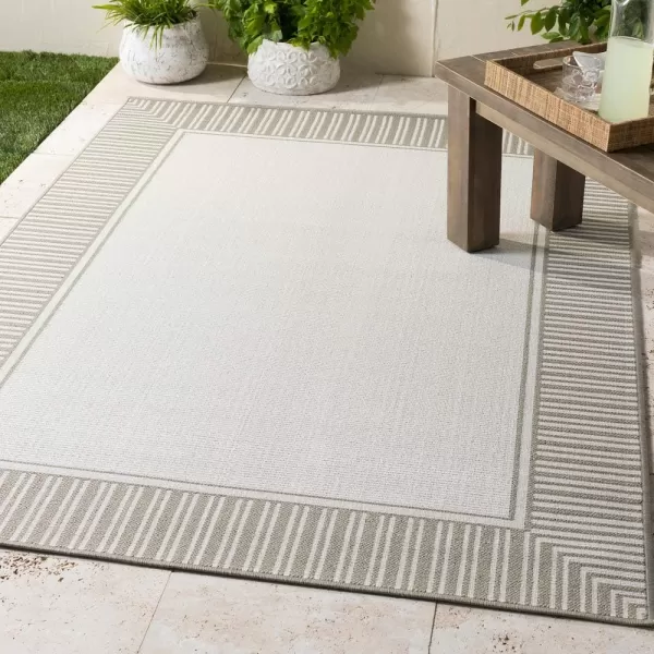 imageLivabliss Hampshire Solid Border Outdoor Area Rug 53quot x 77quot BlackTaupeWhite