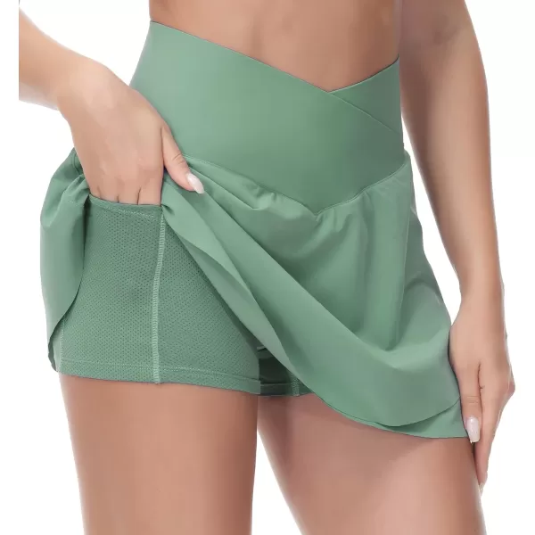 imageTHE GYM PEOPLE Womens Cross Waist Tennis Skirts with Cutting Hem Golf Skorts with Inner Mesh Pockets ShortsJasmine Green